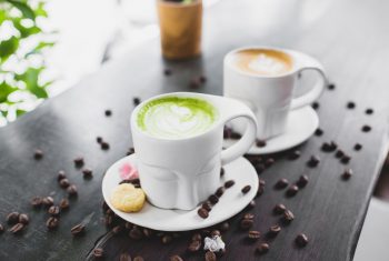 cups-of-cappuccino-and-matcha-tea-served-on-cafe-terrace-4552172